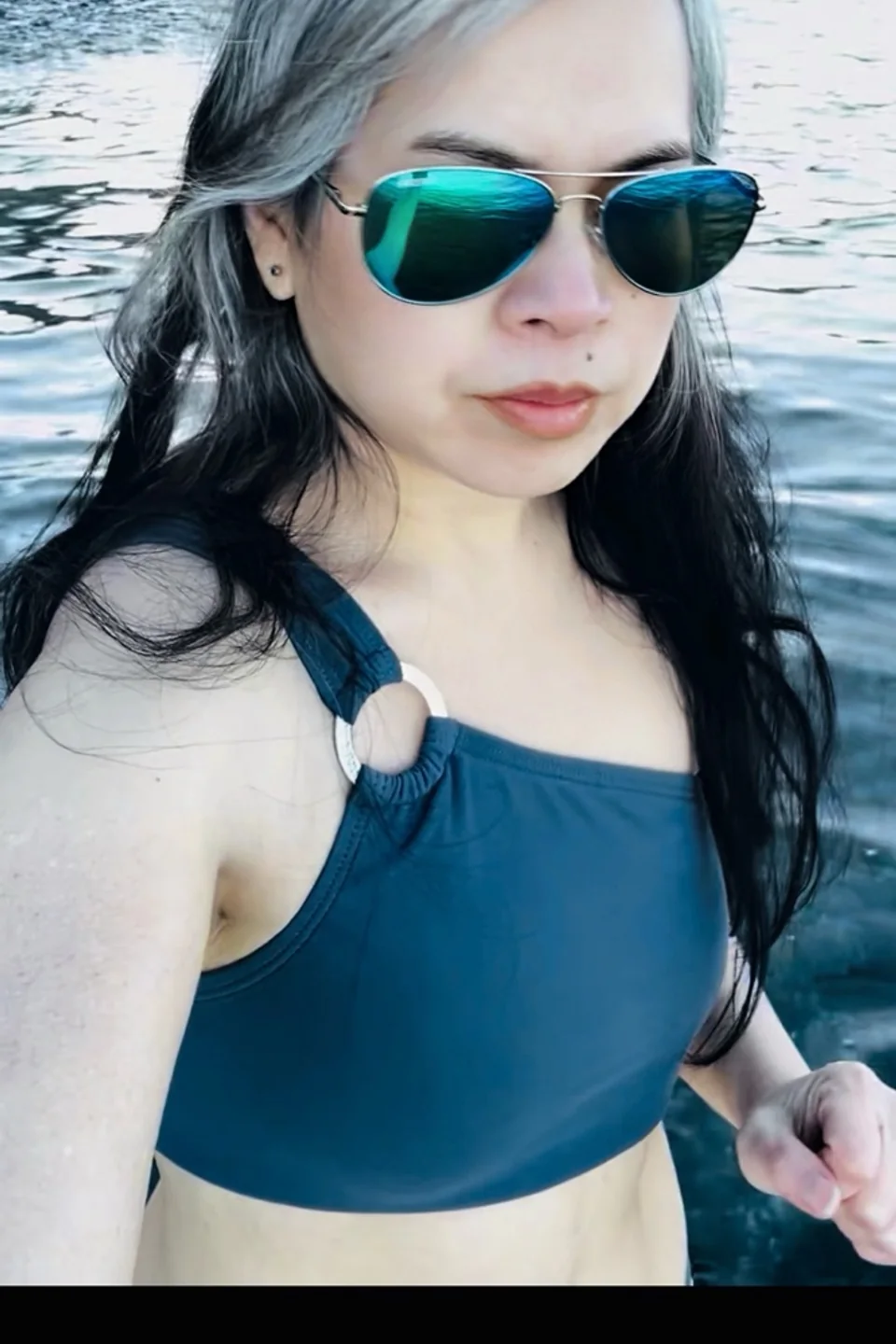 Sou Bounlutay standing in cold Puget Sound water